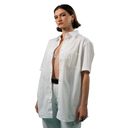 Woman wearing an open white shirt with a pocket on a white background