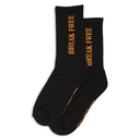 A pair of black crew socks with 'BREAK FREE' printed vertically in orange on the upper leg and orange text on the sole, displayed against a solid white background.