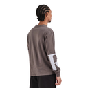 A man shown from the back wearing a dark brown long-sleeve t-shirt with a large white graphic on the left sleeve, paired with black pants, against a plain white background.