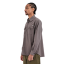 A man in profile wearing a long-sleeve gray button-up Last Resort shirt with a chest pocket, paired with olive green pants, photographed against a plain white background.