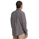 A man viewed from the back wearing a black and white gingham patterned button-down shirt and khaki pants, set against a plain white background.