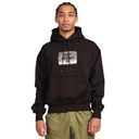 A man wearing a black pullover hoodie with a distressed white graphic on the chest that reads 'LAST RESORT AB'. He is also wearing olive green pants, set against a plain white background.