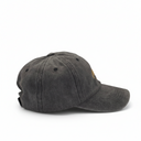 A washed dark gray baseball cap with a small gold embroidered logo on the side, shown from a three-quarters angle against a plain white background.