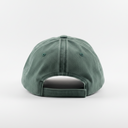 A green baseball cap viewed from the back, resting on a white surface against a white background.