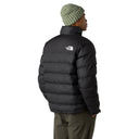 Person wearing a black puffer jacket with a brand logo on a white background