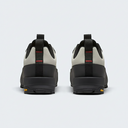 Black and beige shoes with visible brand logo on a light gray background