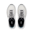 A pair of On Cloudcaster running shoes shown from a top-down view, featuring a white and black design with a small light blue accent on the heel.