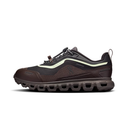 A dark brown and black outdoor sneaker with a light green accent stripe and a distinctive wavy sole, shown from a side profile on a white background.