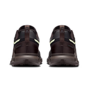 A pair of dark brown trail running shoes shown from the rear, featuring black overlays, a dark brown pull tab with a small logo, and a light yellow-green accent stripe on the sides.