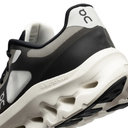 Black and white athletic shoe with 'On' branding on a white background
