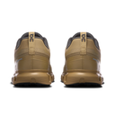 Pair of tan running shoes with black accents on a white background