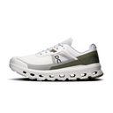 White running shoe with green accents on a white background