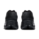 Black athletic sneakers shown from the rear, featuring textured synthetic uppers and chunky black midsoles, set against a plain white background.