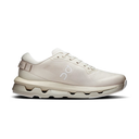 A single low-top athletic sneaker in a light cream/off-white colorway, shown in a clean side profile against a solid white background. The shoe features a textured mesh upper, a thick chunky midsole with visible air cushioning, and a matching light beige heel strap.