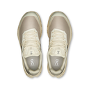 Pair of beige running shoes on a white background