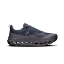 A dark gray and navy blue athletic shoe with a distinctive wavy sole, shown in a side profile on a white background.
