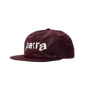 A dark brown corduroy flat-brim cap featuring a white embroidered shark outline logo on the front, set against a plain off-white background.