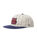 A baseball cap with an off-white pinstripe crown, a navy blue flat brim, and a colorful embroidered cat face on the front. The side displays a small black script logo reading 'Pines'.