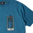Blue t-shirt with a graphic design of a hand holding a flame and the text 'THE' on a white background.