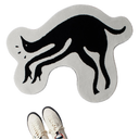 A black cat silhouette rug in a light gray color, shown with a pair of off-white sneakers at the bottom to indicate scale.