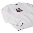 A light heather gray crewneck sweatshirt featuring a square graphic patch on the left chest with a stylized red and black figure on a white background.
