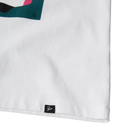 Close-up of a white textile product corner with a small black sewn-in label reading 'Rome' and a partial abstract graphic in teal, pink, black, and white.