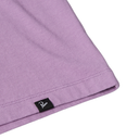 Close-up of a purple fabric with a brand label on a white background