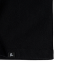 Close-up of a black ribbed knit garment corner with a small black brand tag reading 'Poncho' on a white background.