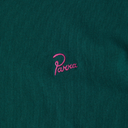 Pink embroidered logo on a teal fabric background