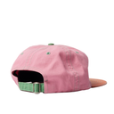 Pink cap with green strap on a white background