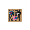 Three circular enamel pins displayed on a brown kraft card with the text 'SOME DITTON'S'. The pins feature vibrant pink, blue, and black designs, including a stylized face, a black-and-white script logo reading 'Parra', and a pink and blue abstract design.