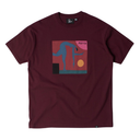 A maroon short-sleeve crewneck t-shirt featuring a colorful graphic print on the chest of a stylized blue figure in front of a red and pink square with a yellow circle and the word 'PATTY'.