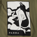 Close-up of a graphic print on an olive green garment, featuring a black and white abstract figure design with the word 'PARRA' at the bottom.