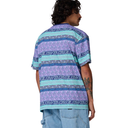 Person wearing a patterned shirt with a white background
