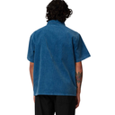 Person wearing a blue denim shirt on a white background