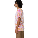 Person wearing a tie-dye shirt with pink and orange patterns on a white background