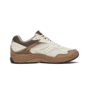 A single athletic sneaker shown in a side profile view against a solid white background. The shoe features a cream-colored mesh upper, brown synthetic overlays, a brown heel collar, and a thick brown midsole with a black outsole.