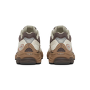 A pair of Skechers sneakers shown from the back, featuring a color palette of brown, beige, and gray with textured mesh and chunky soles.
