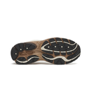 The outsole of a hiking shoe shown from a top-down view, featuring a brown and black tread pattern with white lugs and white stitching details, set against a plain white background.