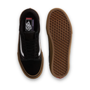 Black sneaker with brown sole on a white background
