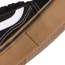 Close-up of a black and white sneaker with brown sole showing 'Superga' branding.