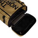 Open beige backpack with black interior and visible brand name on a white background