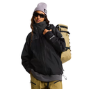 Person wearing a black jacket, gray beanie, and sunglasses, holding a beige backpack on a light gray background.