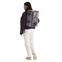 Person wearing a gray backpack with 'The North Face' logo on a white background