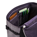 Purple backpack with compartments containing stationery items on a white background