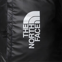 Close-up of a black waterproof bag with a large white The North Face logo printed vertically on the side.