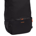 A close-up of a black backpack showing its front mesh pocket, zipper pulls, and orange logo details against a white background.