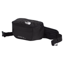 A black waist bag from The North Face, featuring a zippered main compartment, a white logo on the front, and an adjustable black webbing strap with a buckle, shown against a plain white background.