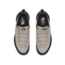 A pair of The North Face low-top sneakers shown from a top-down view, featuring light beige suede and mesh uppers with black soles and black interior lining.