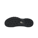 The black rubber outsole of a hiking shoe, showing deep tread patterns and the white embossed logo of The North Face on the heel, isolated on a white background.